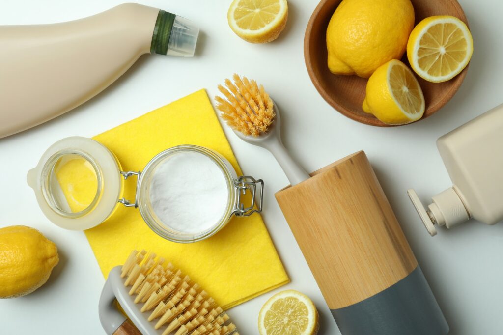 Cleaning concept with eco-clean tools and lemons on white background